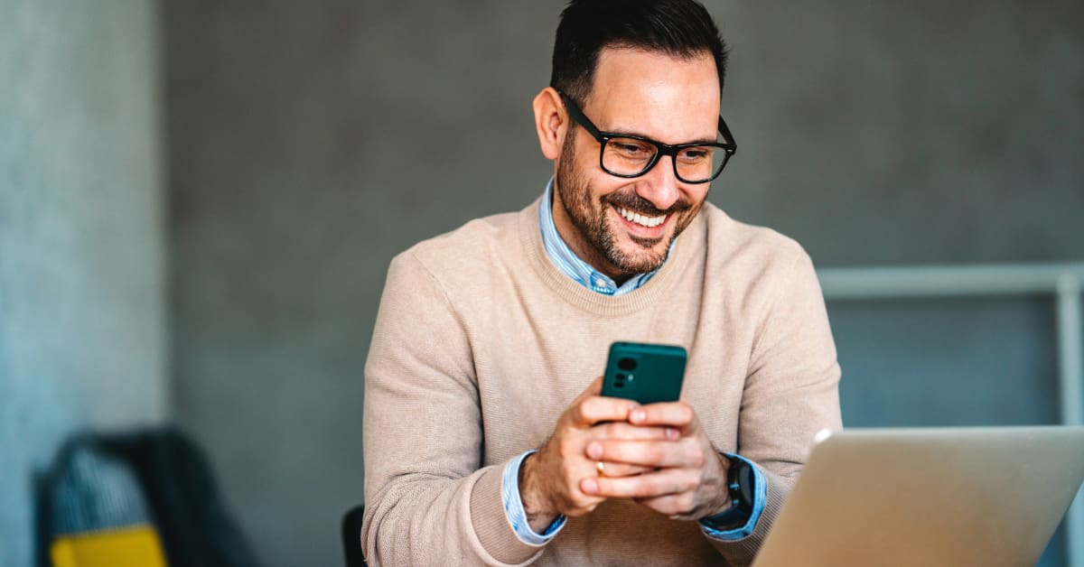 Business owner using AI phone system Business owner using AI phone system